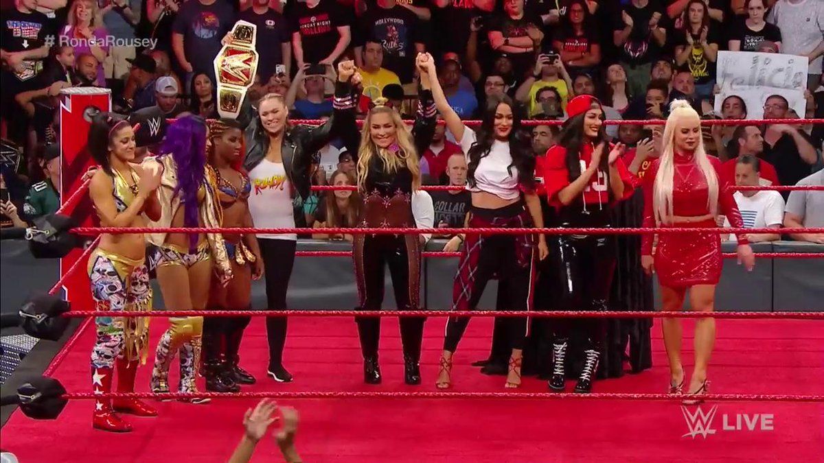 Left to right: Bayley, Sasha Banks, Ember Moon, Ronda Rousey, Natalya, Brie Bella, Nikki Bella, Dana Brooke. (source: WWE)