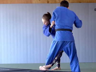 Ronda Rousey performing a judo sweep.